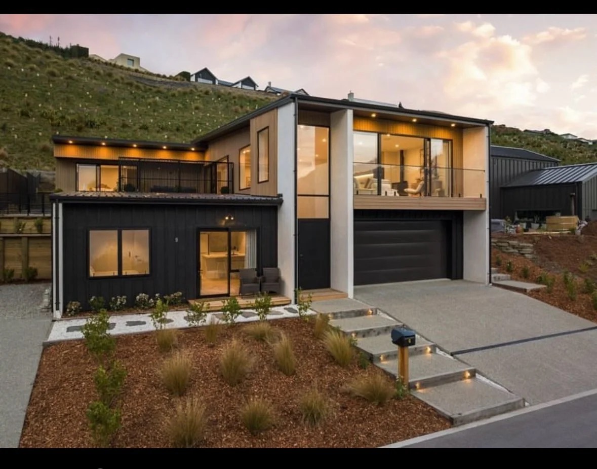 Cedar-clad two-storey home with landscaped backyard